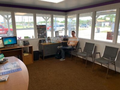 inside Trinity Auto Service offices and an agent on the computer staying busy